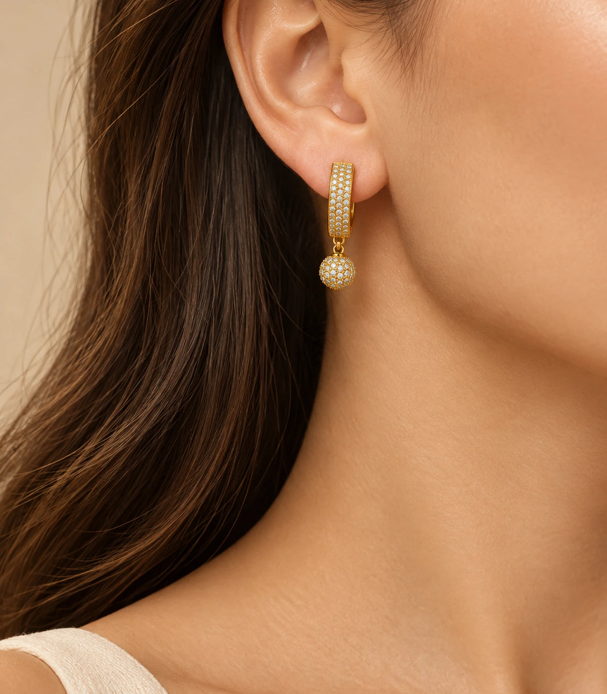 JIMIKI Gold-Tone Three-Row Pavé Ball Drop Huggie Earrings — earrings styled with an outfit #color_gold-tone / clear