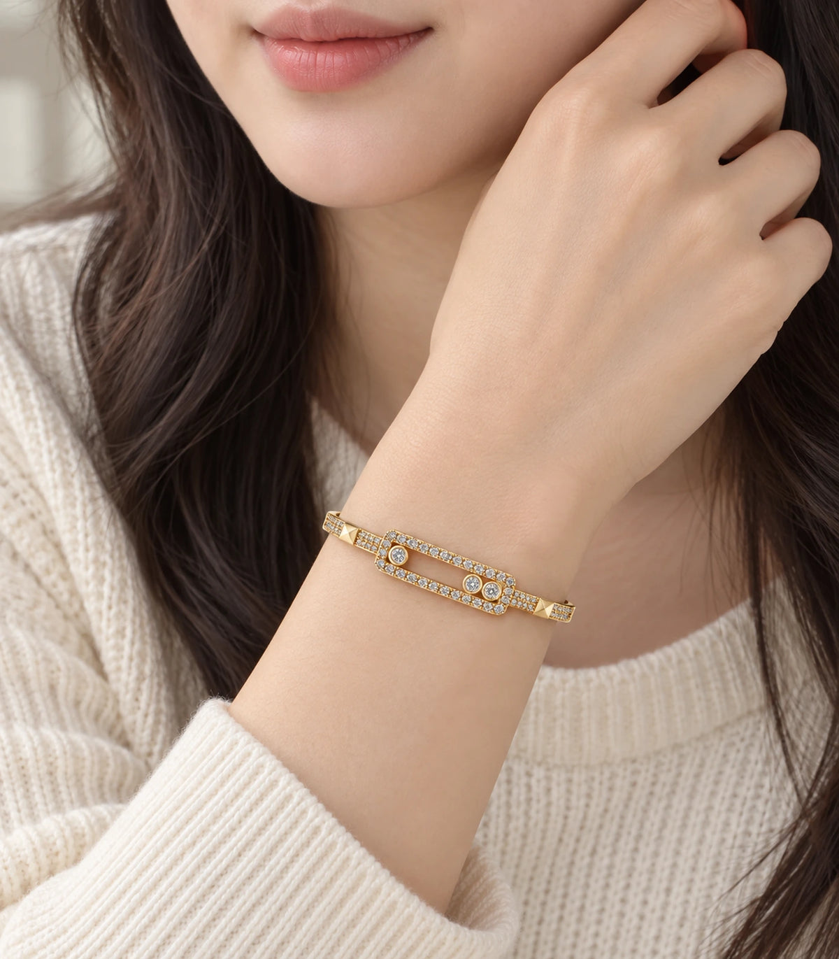 JIMIKI Gold-Tone Three Stone Open Rectangle Bangle — worn on the wrist #color_gold-tone / clear