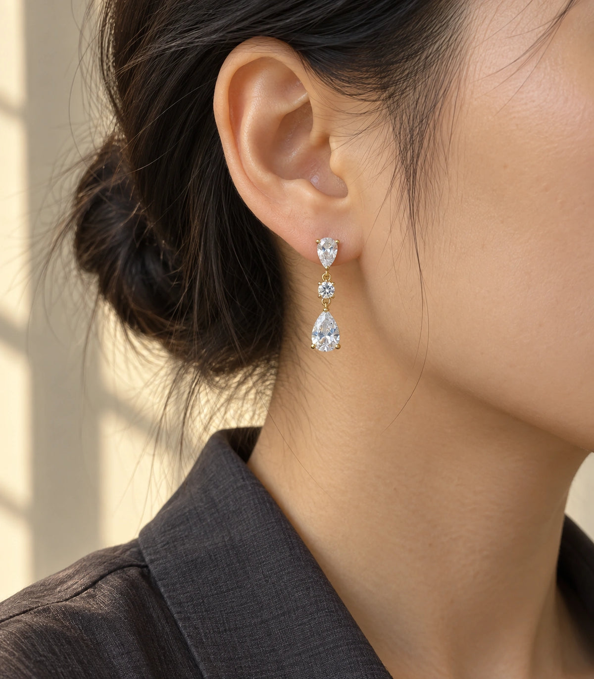 JIMIKI Gold Tone Three Stone Pear Drop Earring Pair in Gold-tone, editorial model view