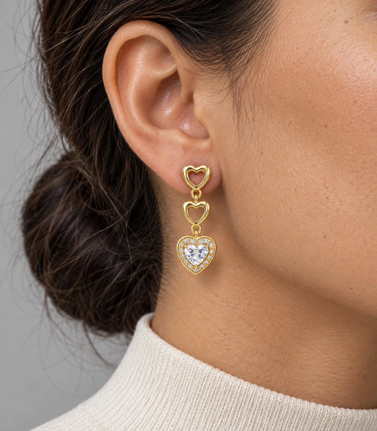 JIMIKI Triple Heart Crystal Drop Earring Pair in Gold tone / clear, close-up detail #color_gold tone / clear