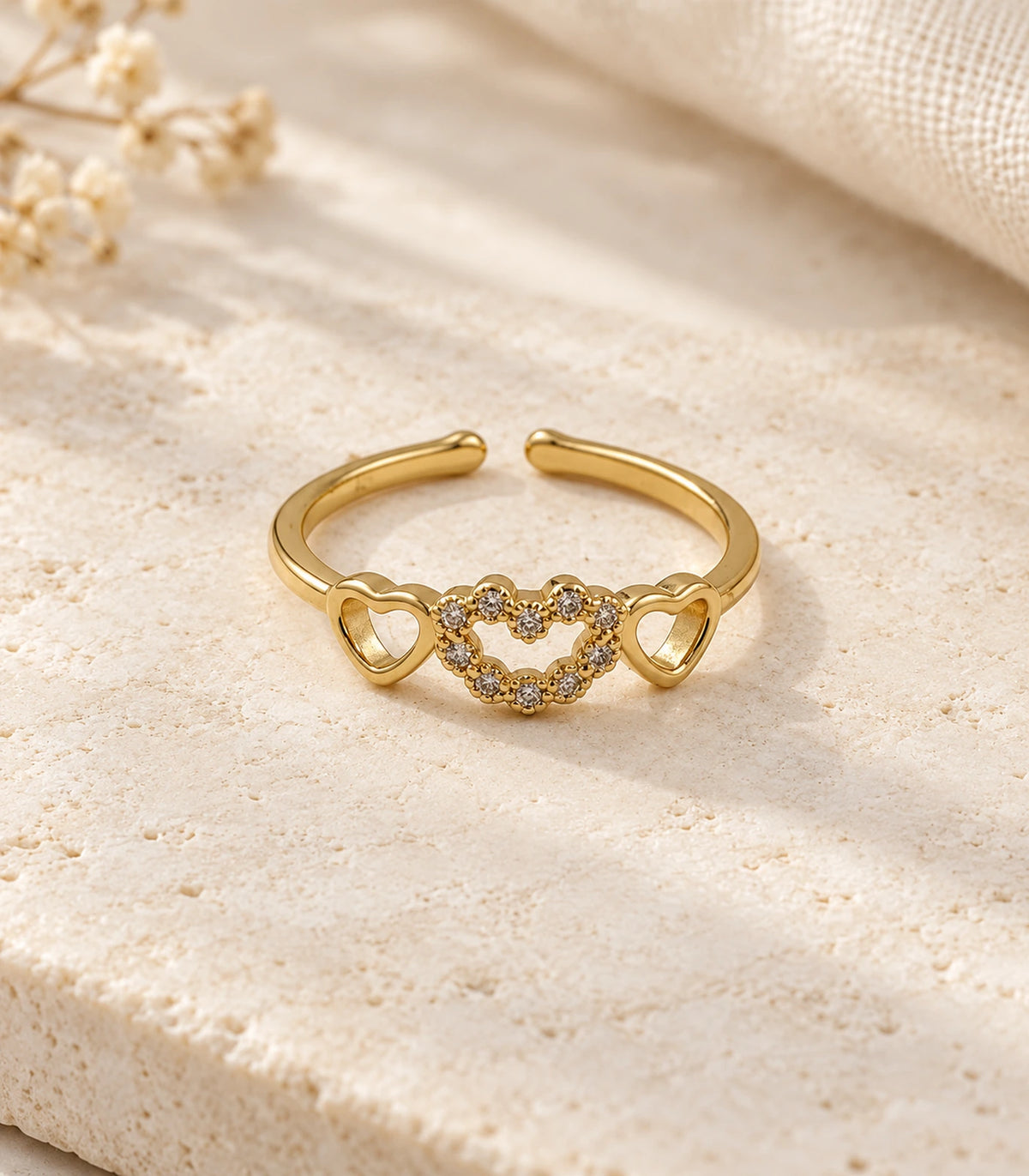 JIMIKI Triple Heart Crystal Adjustable Ring in Gold Tone - editorial flatlay #color_gold-tone