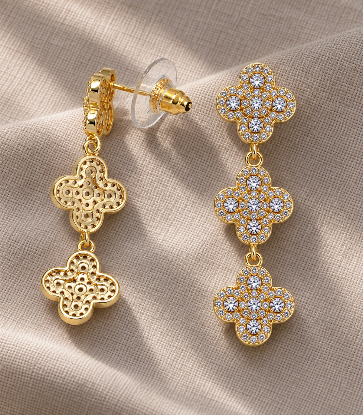 JIMIKI Pave Triple Quatrefoil Drop Earring Pair in Gold tone, editorial flat lay #color_gold tone