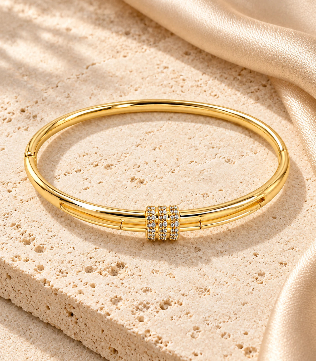 JIMIKI Gold-Tone Triple Pavé Band Double-Rail Bangle — bangle in a styled flat lay #color_gold-tone / clear