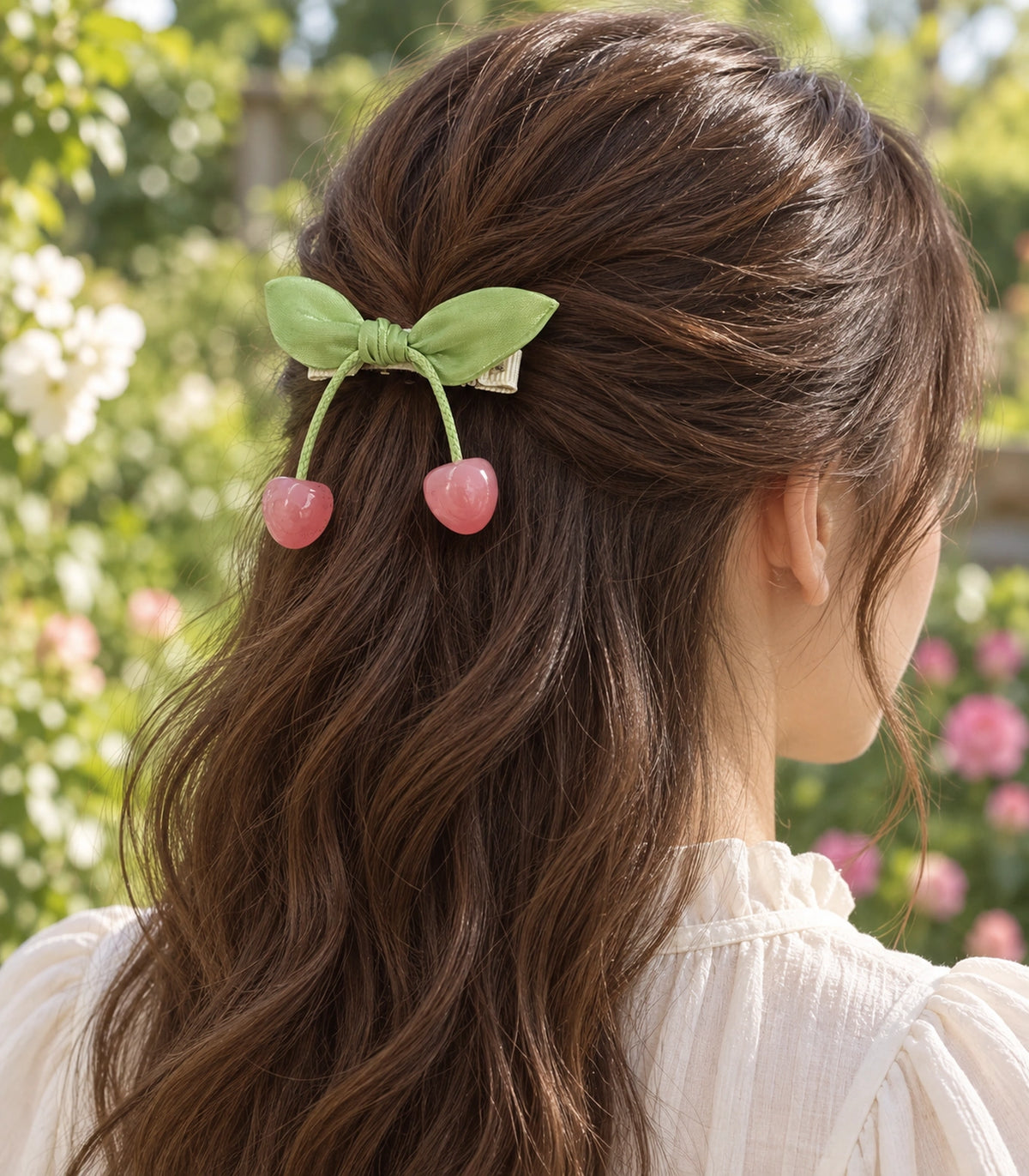 JIMIKI Green Leaf Bow Hair Clip with Cherry Charms in Green, editorial model view