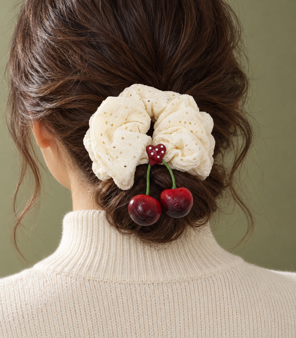 Ivory eyelet cherry scrunchie with dotted heart centre — editorial model view
