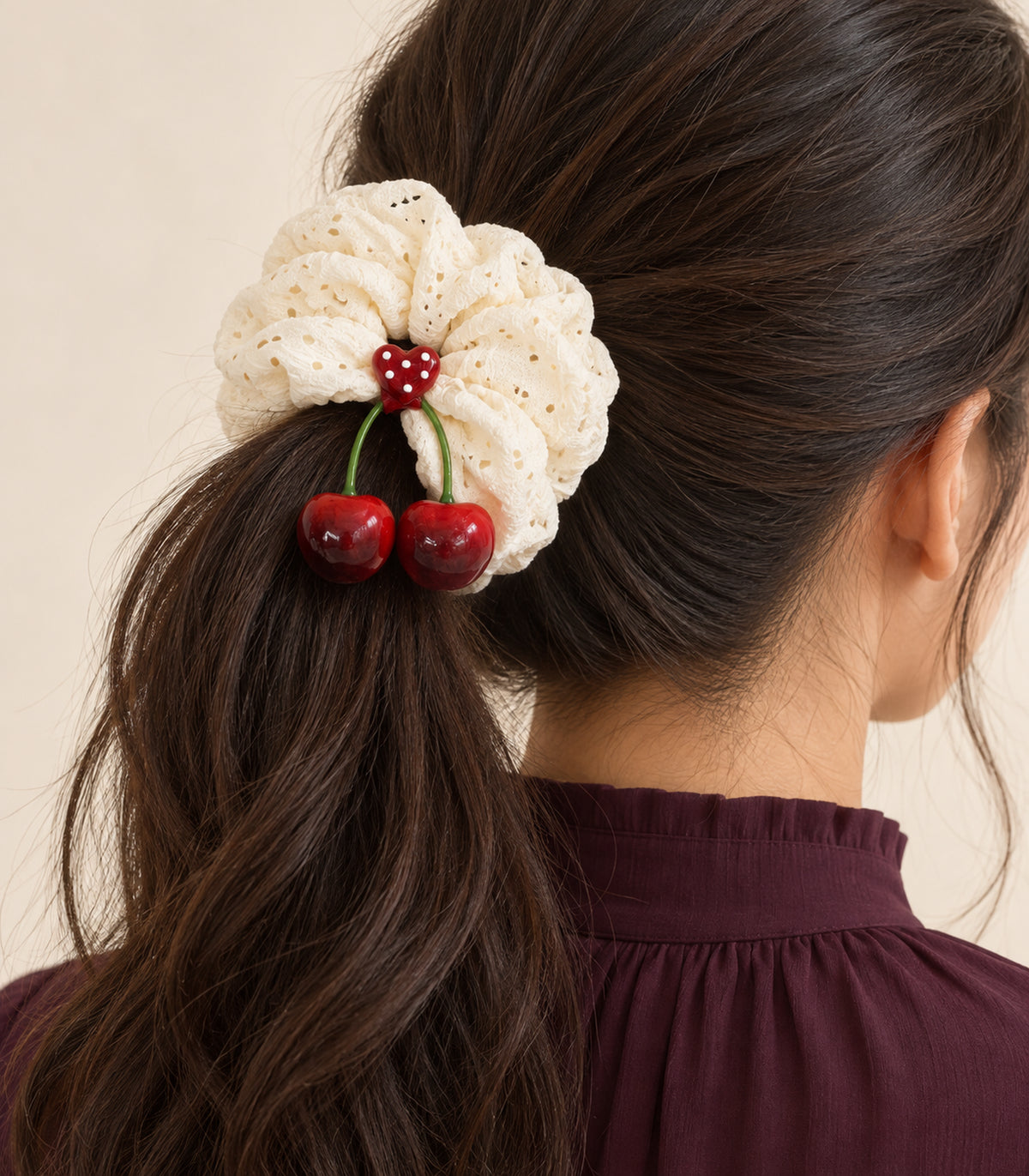Ivory eyelet cherry scrunchie with dotted heart centre — model view