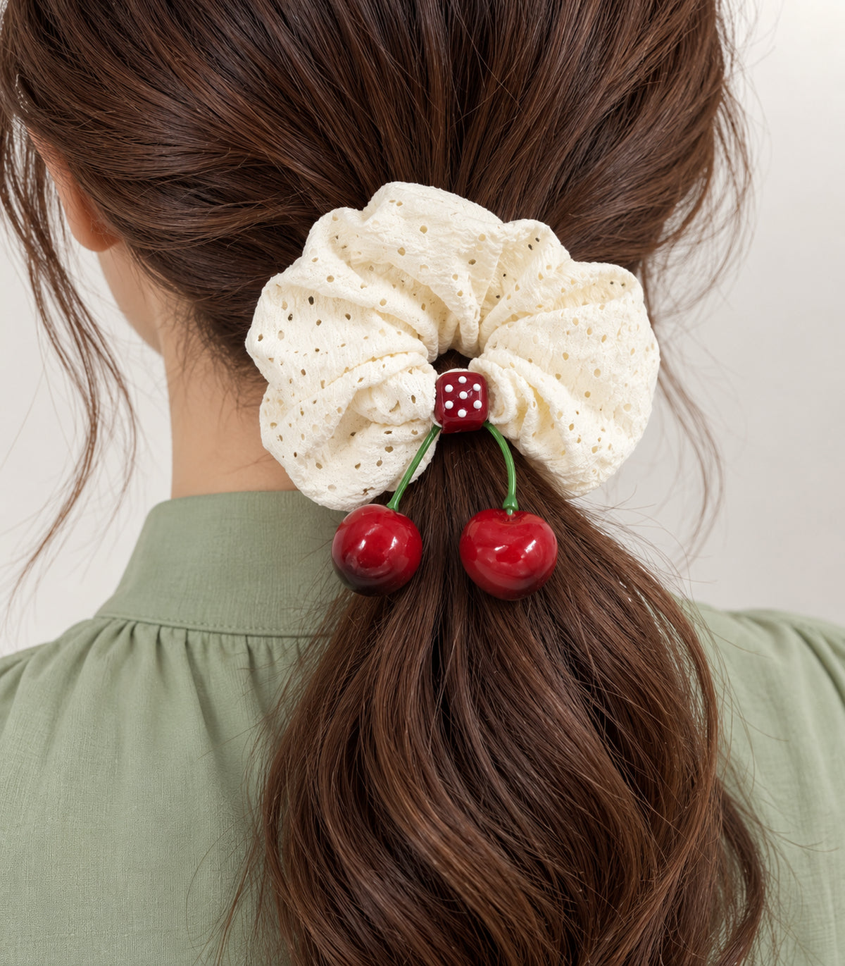 Ivory eyelet cherry scrunchie with dotted square centre, closeup