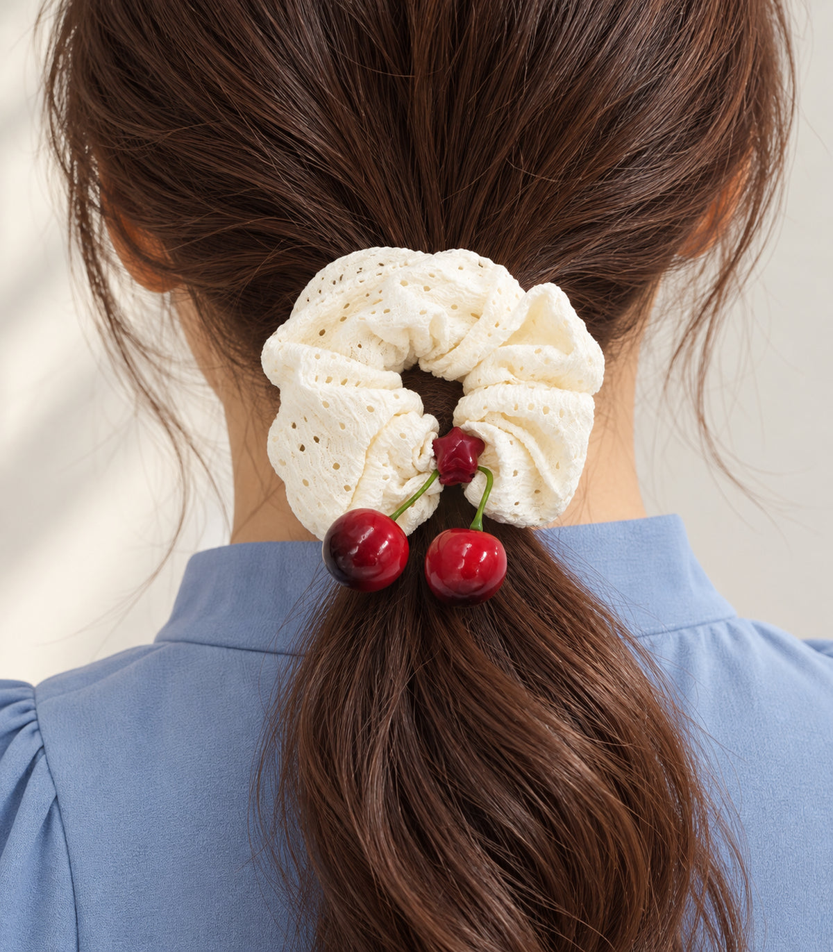 Ivory eyelet cherry scrunchie with red star centre — closeup