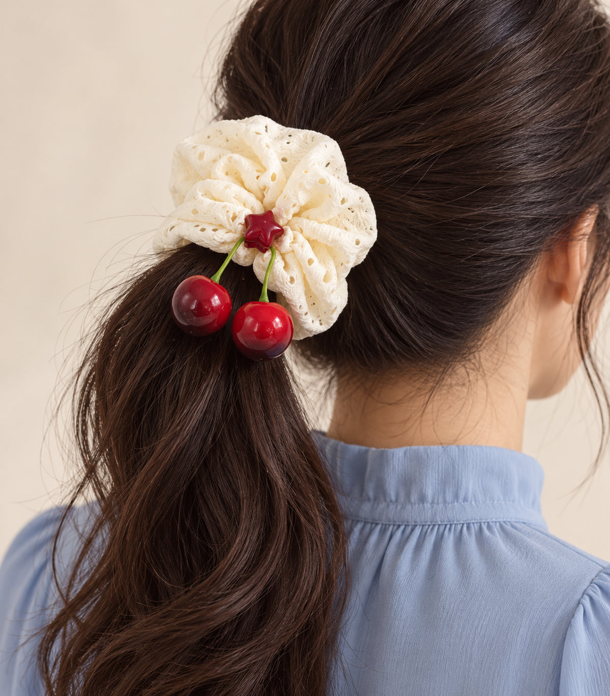 Ivory eyelet cherry scrunchie with red star centre — model