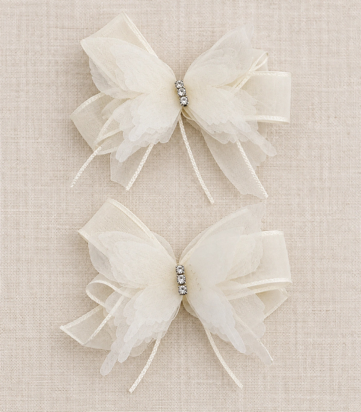 JIMIKI Organza Butterfly Bow Hair Clips in Ivory, editorial flat lay #color_ivory