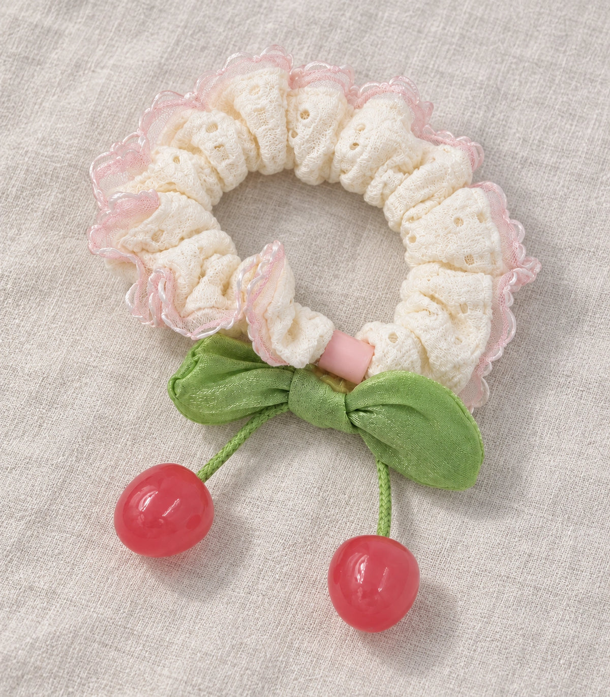 JIMIKI Ivory Pink-Trim Lace Cherry Scrunchie in Ivory/Pink/Green, editorial flat lay