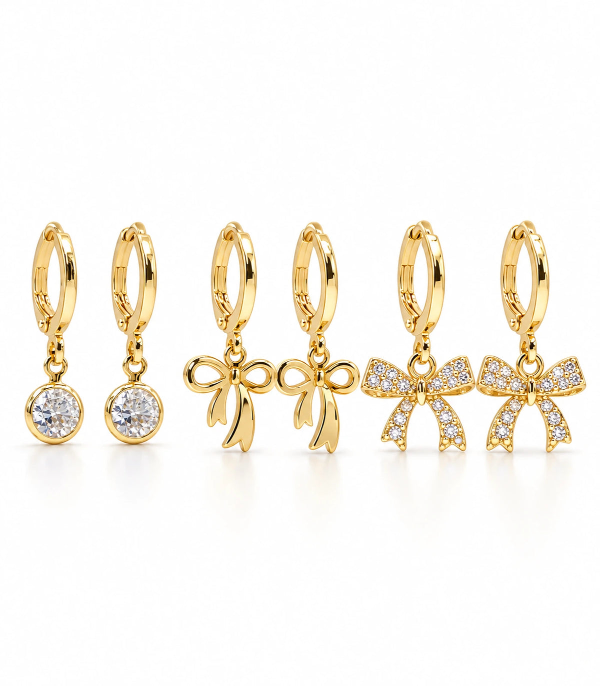 Complete gold tone three-pair hoop earring set: clear crystal drops, polished ribbon bows and crystal-covered ribbon bows.