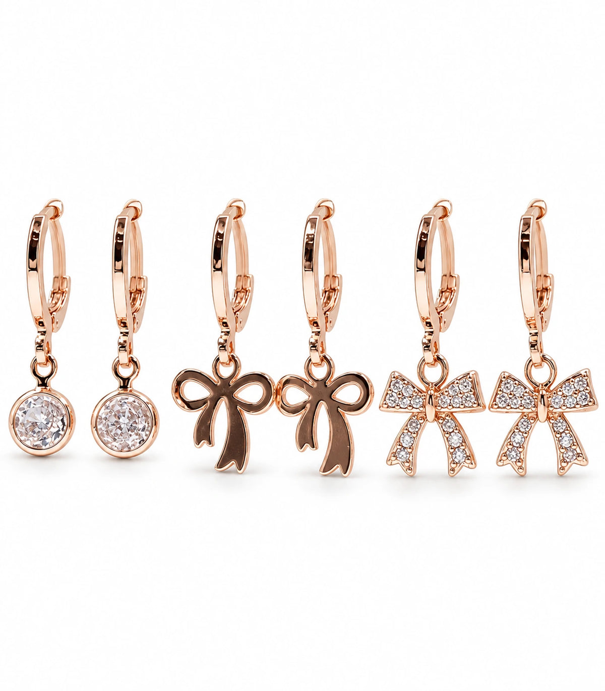 Complete rose gold tone three-pair hoop earring set: round clear crystals, smooth ribbon bows and crystal ribbon bows; six earrings