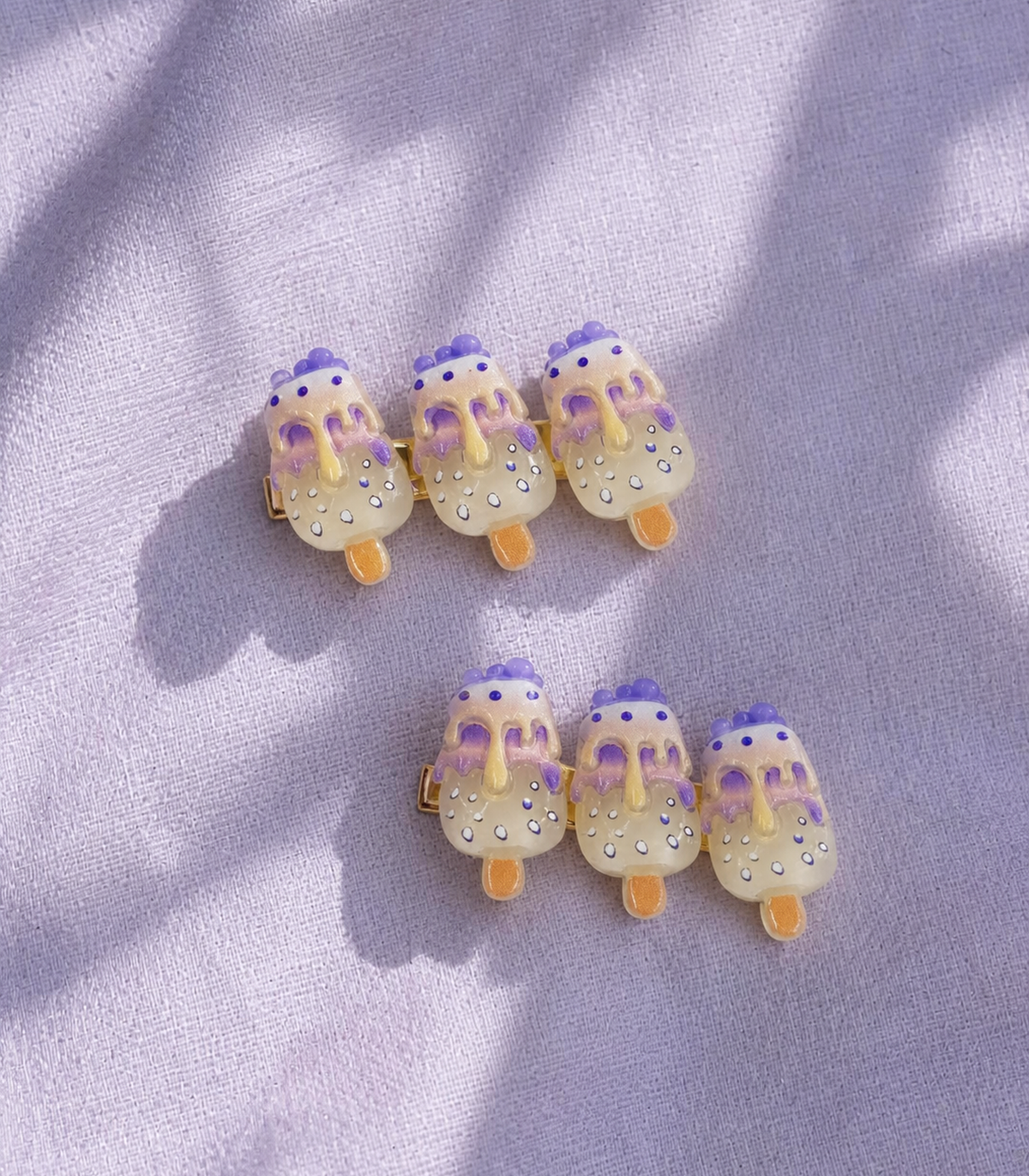 Lavender Iced Pop Trio Clip Pair in an editorial flat lay