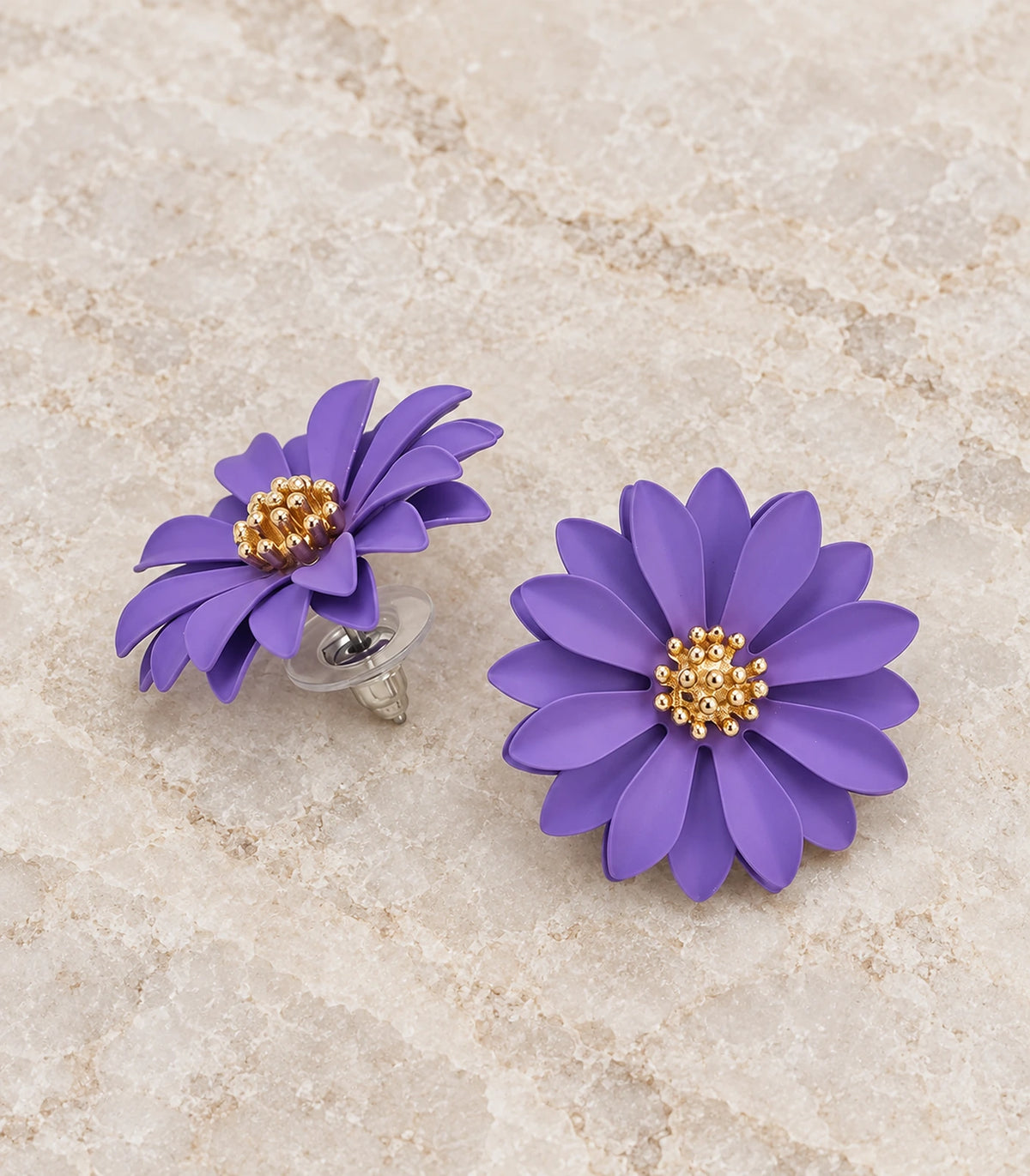 JIMIKI Lavender layered starburst daisy stud earrings, matching pair in a styled flat lay #color_lavender