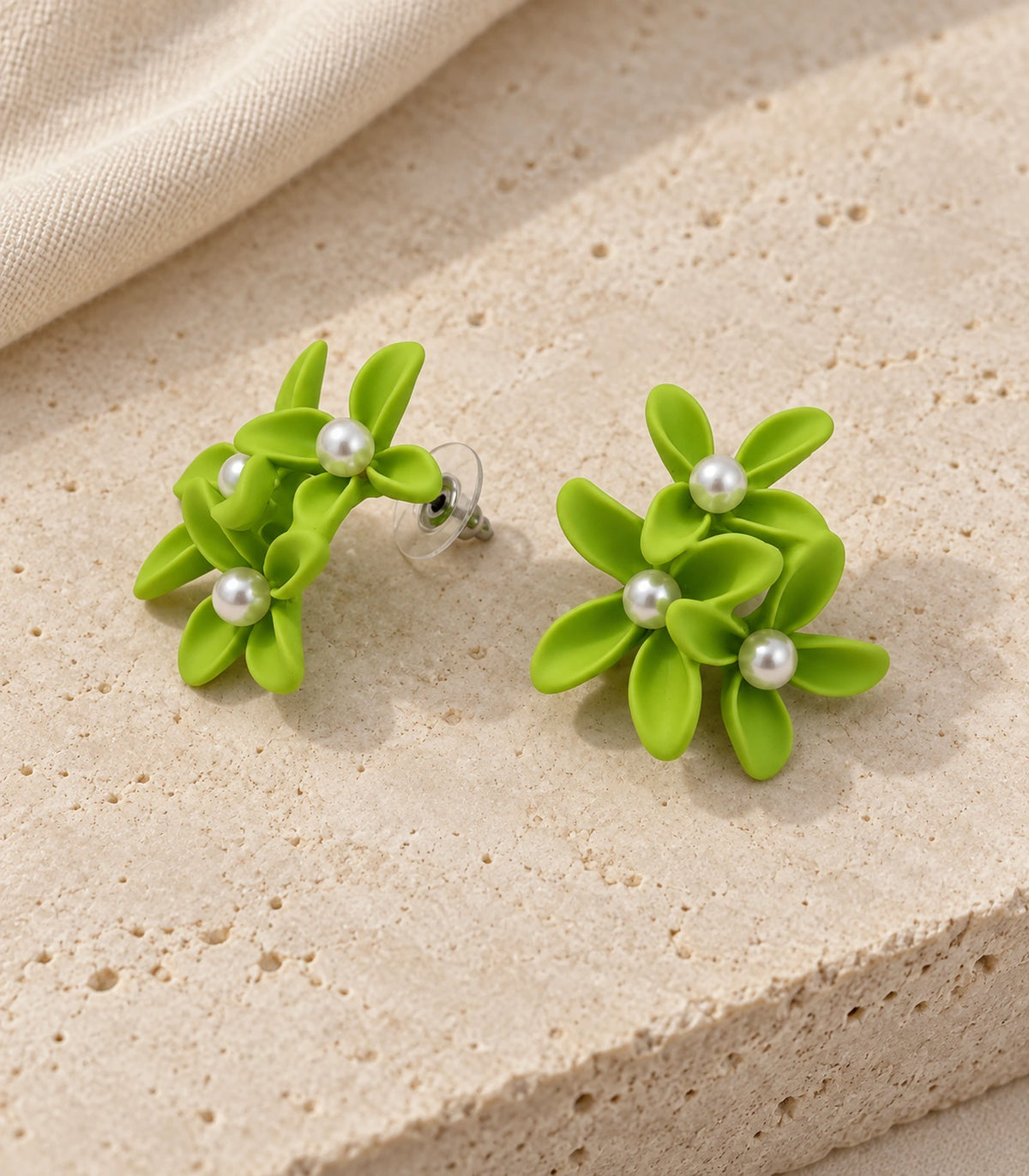 JIMIKI Lime cascading floral cluster stud earrings, matching pair styled on a light textured surface #color_lime