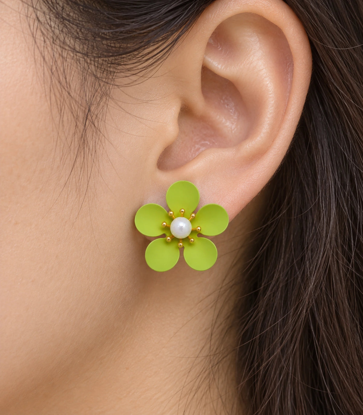 JIMIKI lime five-petal flower stud earrings with pearl-effect centre, closeup of flower stud in a natural worn setting #color_lime