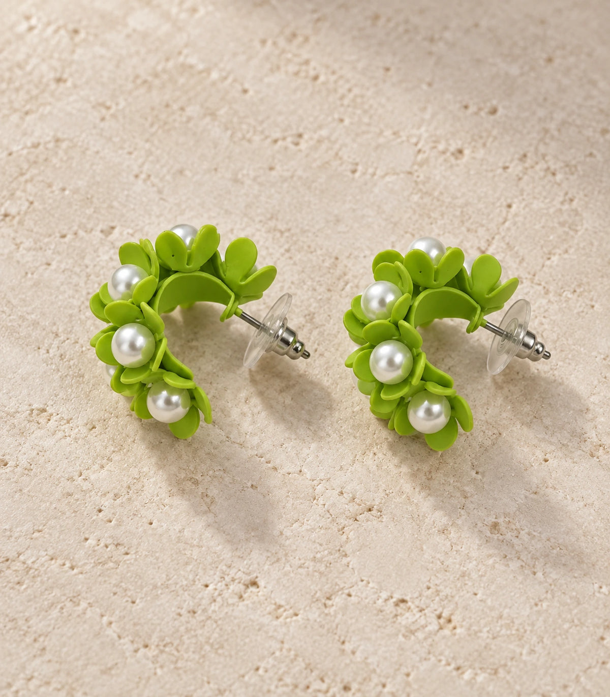 JIMIKI Lime pearl flower hoop earrings, matching pair styled on a light textured surface #color_lime