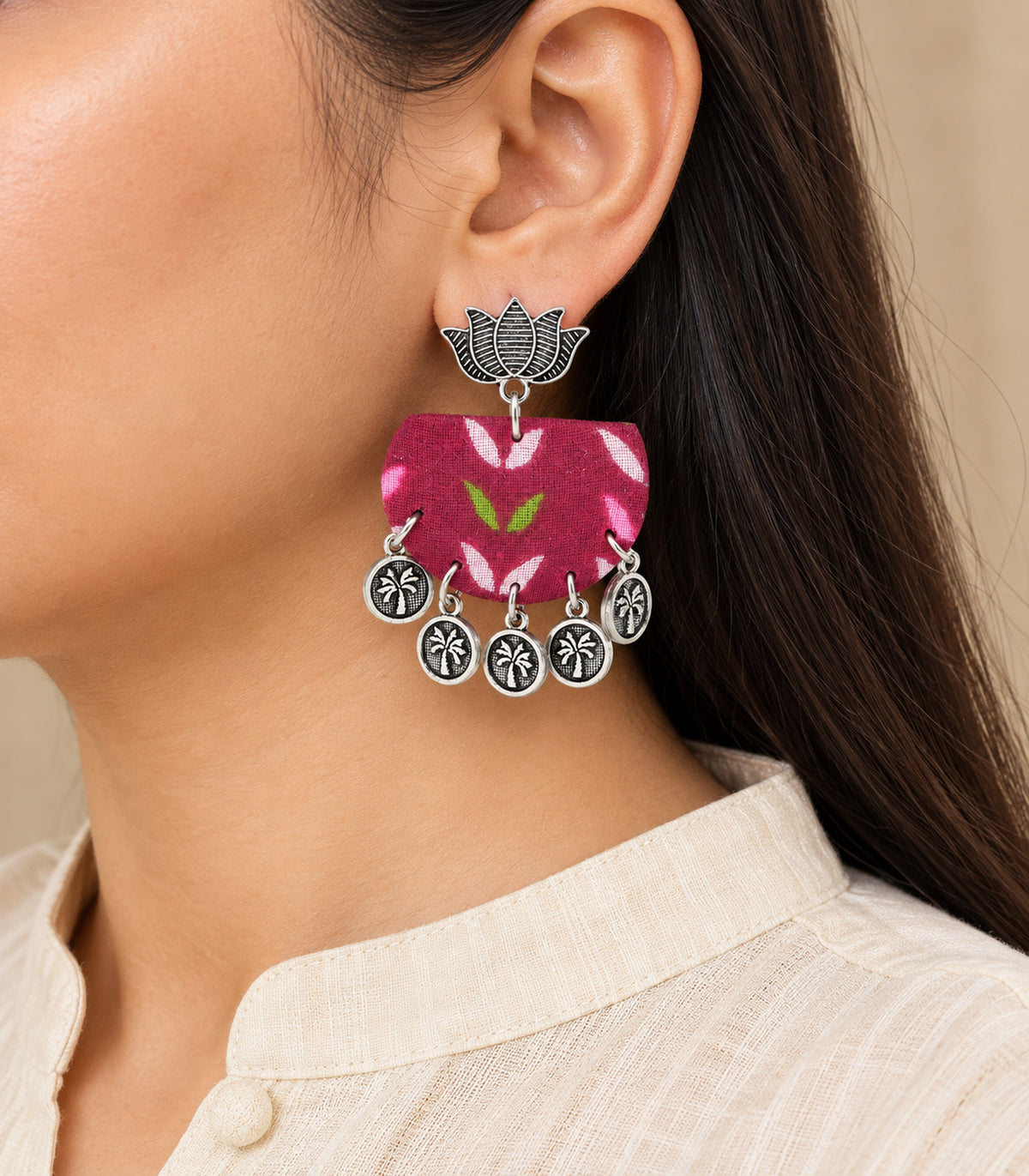 Magenta leaf fabric lotus coin earrings — model single earring detail