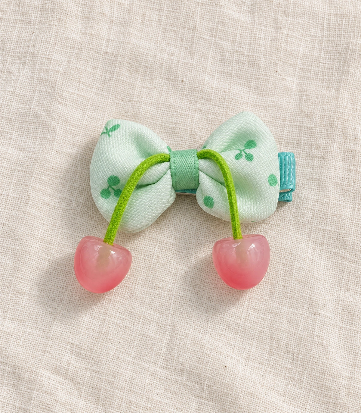 JIMIKI Cherry Print Bow Hair Clip With Cherry Charms in Mint, editorial flat lay #color_mint