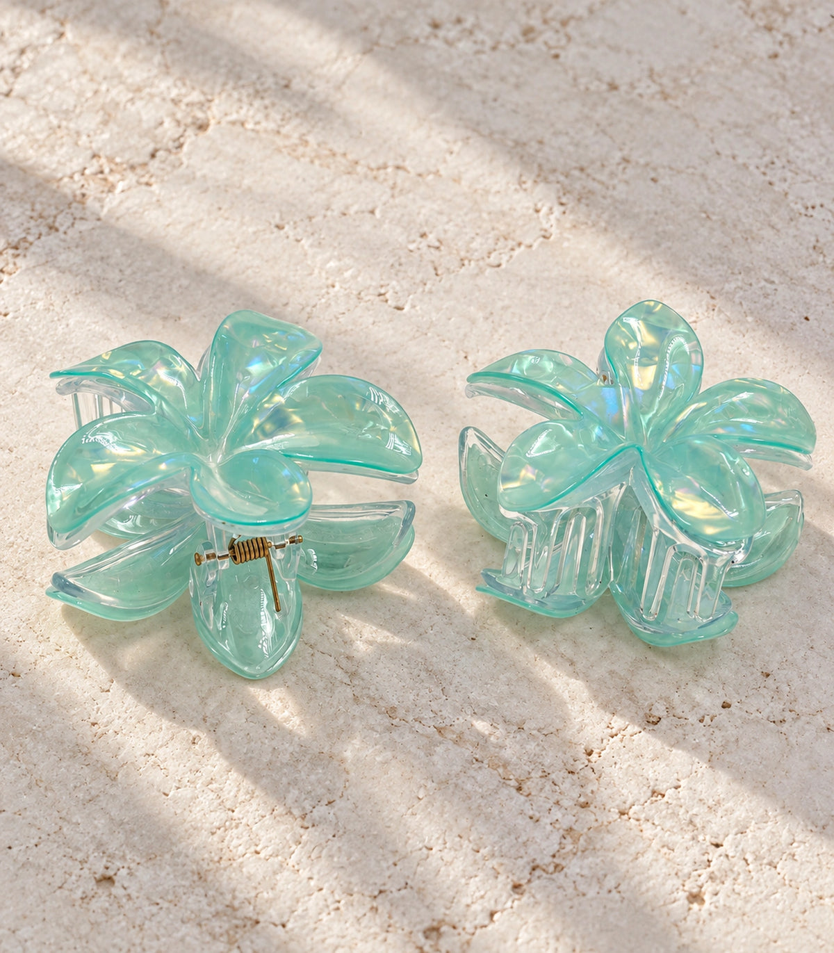 JIMIKI Iridescent Five Petal Flower Hair Claw Clips in Mint, editorial flat lay #color_mint