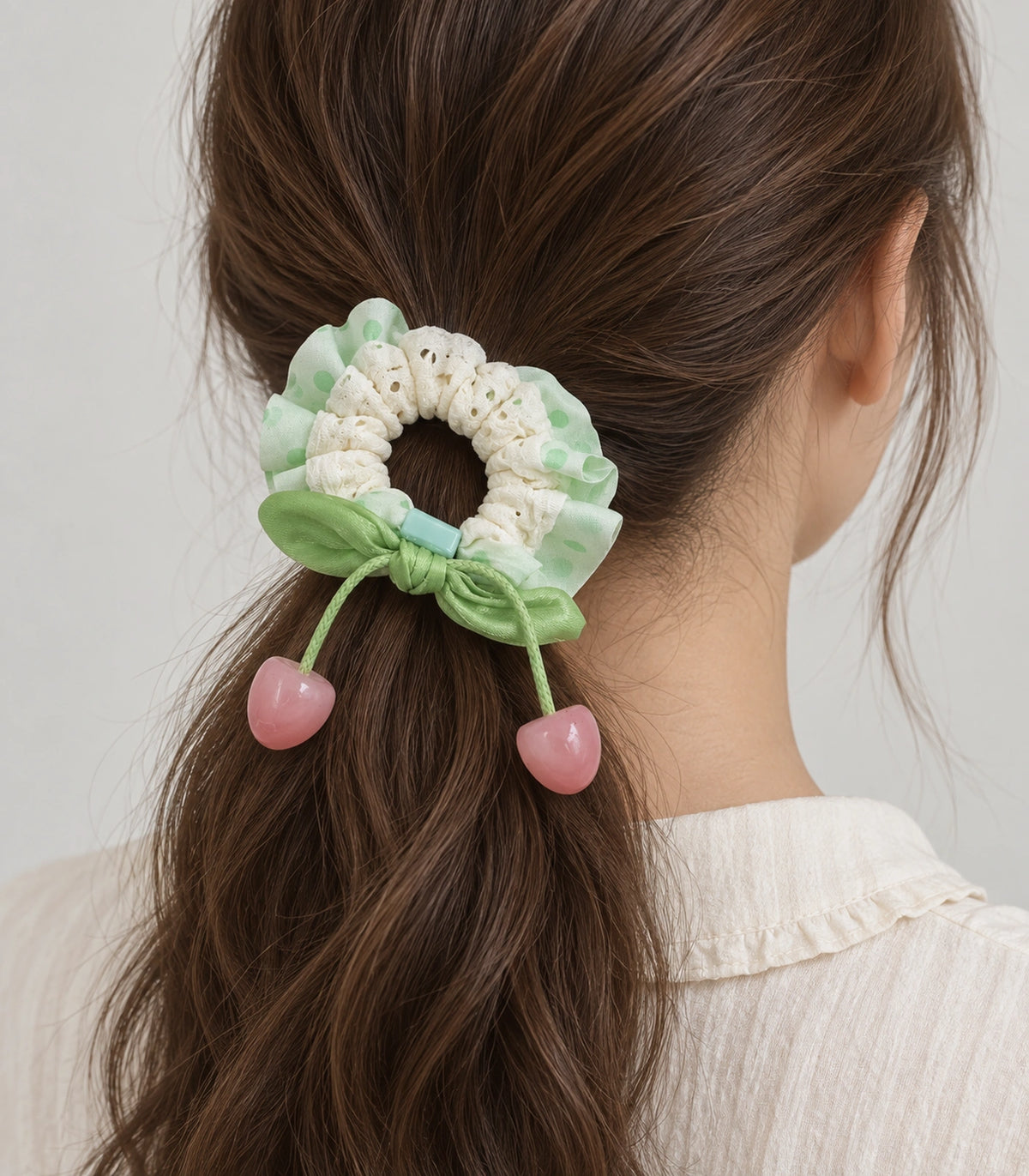 JIMIKI Polka Dot Lace Scrunchie With Cherry Charms in Mint, model wearing view #color_mint