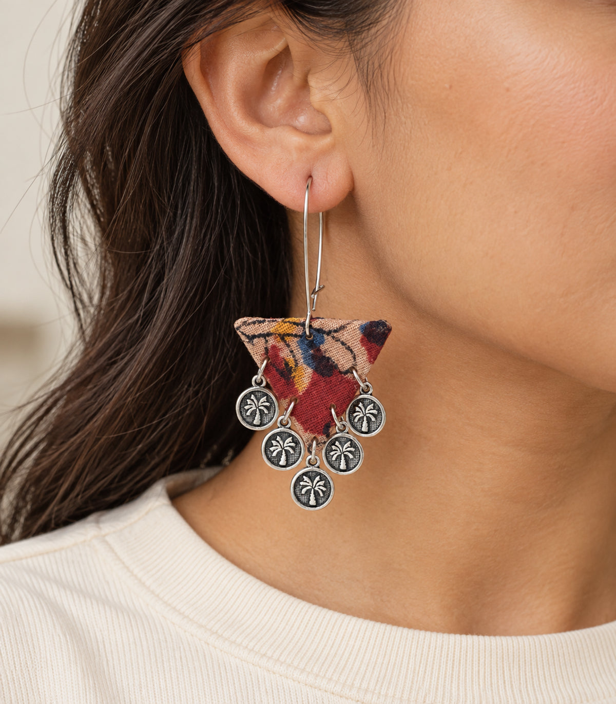 Multicolour triangle fabric coin earrings — closeup of patterned fabric and silver-tone coin drops