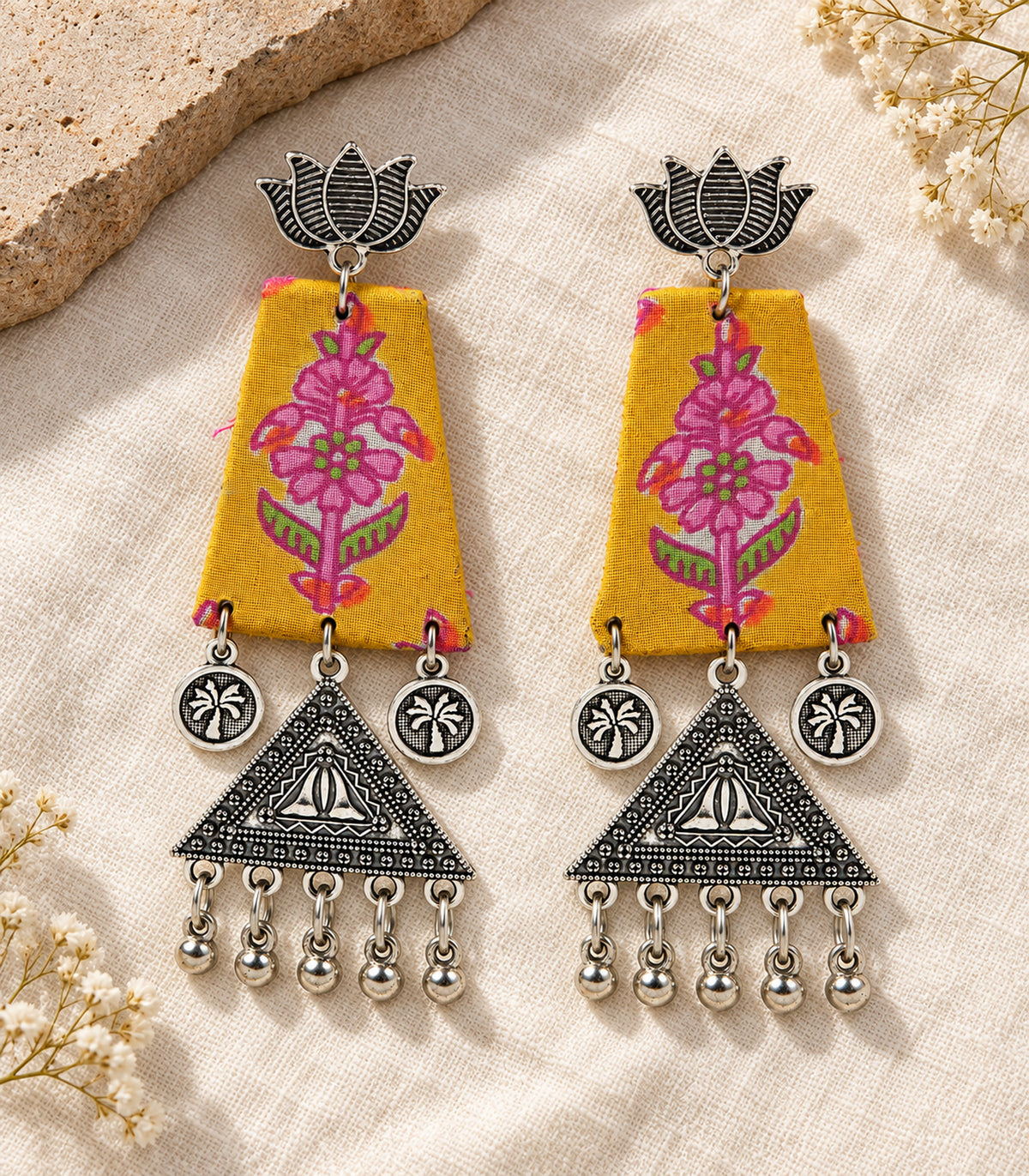 Mustard floral fabric lotus triangle earrings - complete pair in editorial flatlay