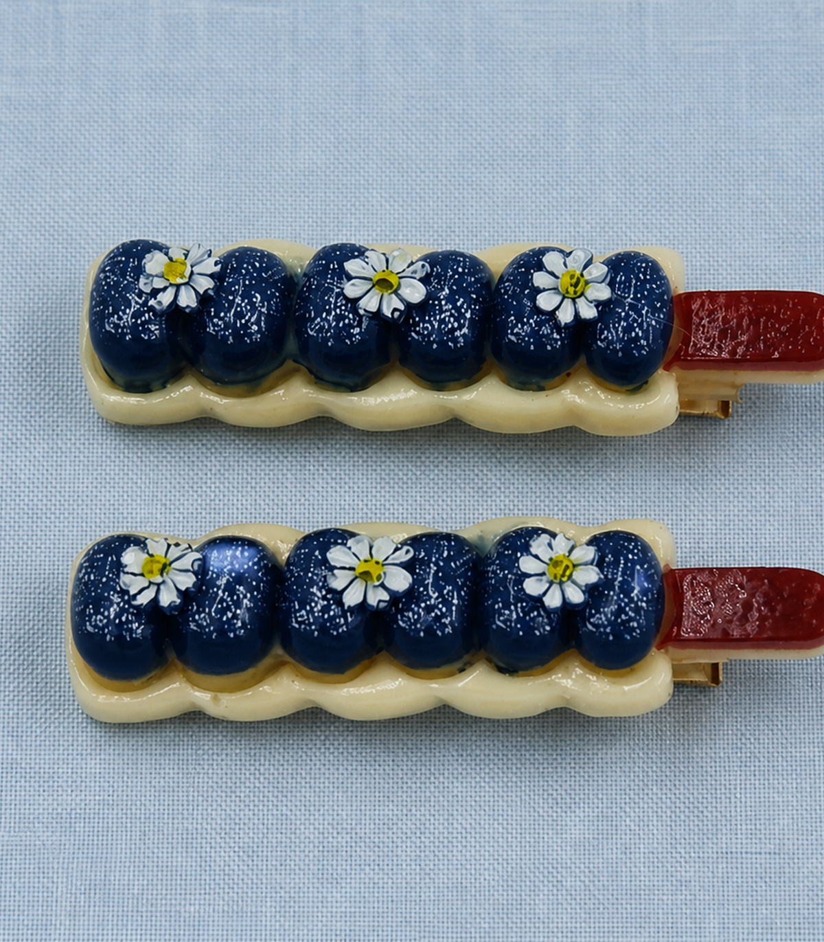 Navy Blueberry Daisy Garland Clip Pair in close-up detail