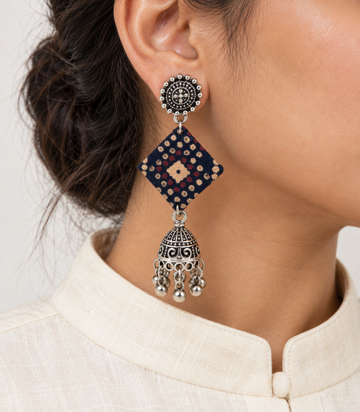 Navy dotted diamond fabric jhumka earrings — closeup