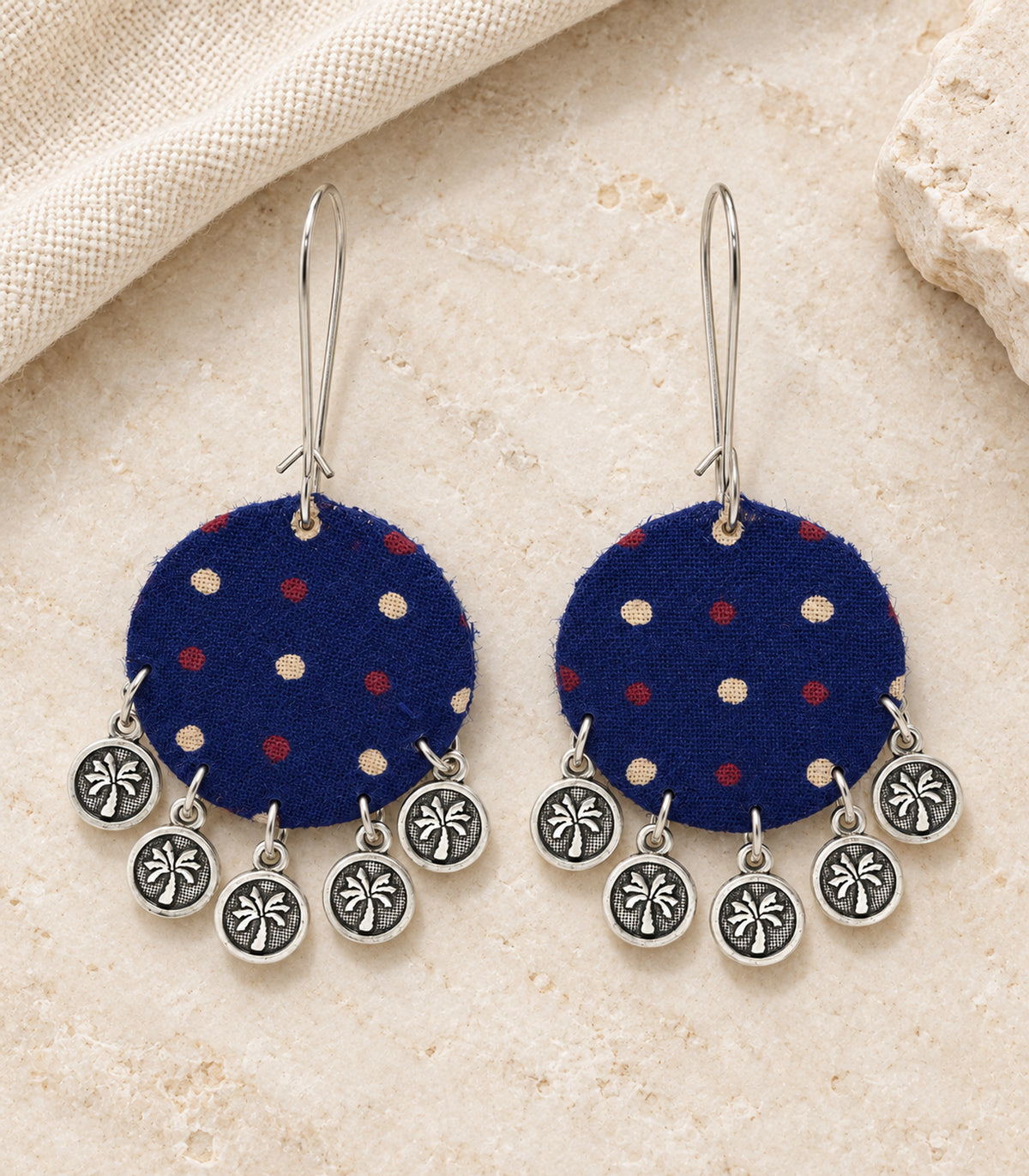 Navy dotted round fabric coin earrings - editorial flatlay view