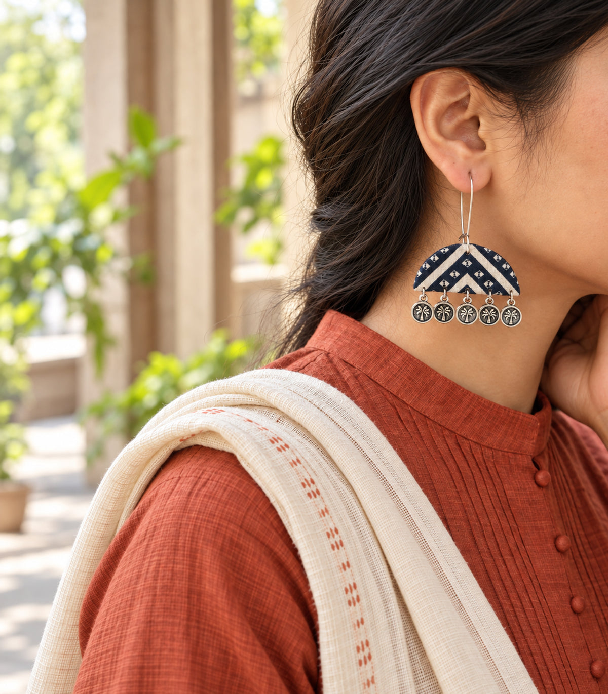 Editorial worn view of navy and ivory chevron flower coin earring