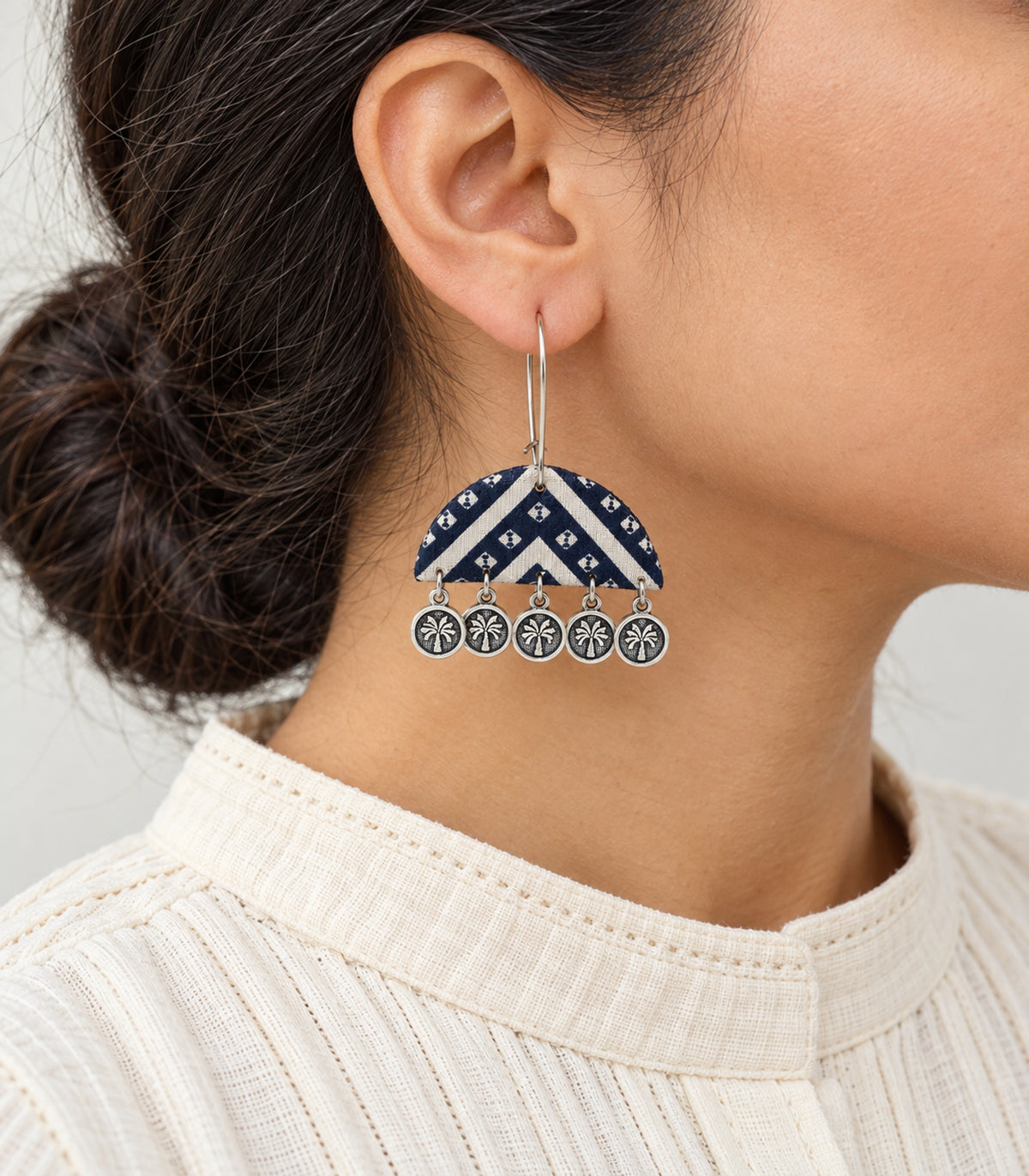 Navy and ivory chevron flower coin earring worn in side view