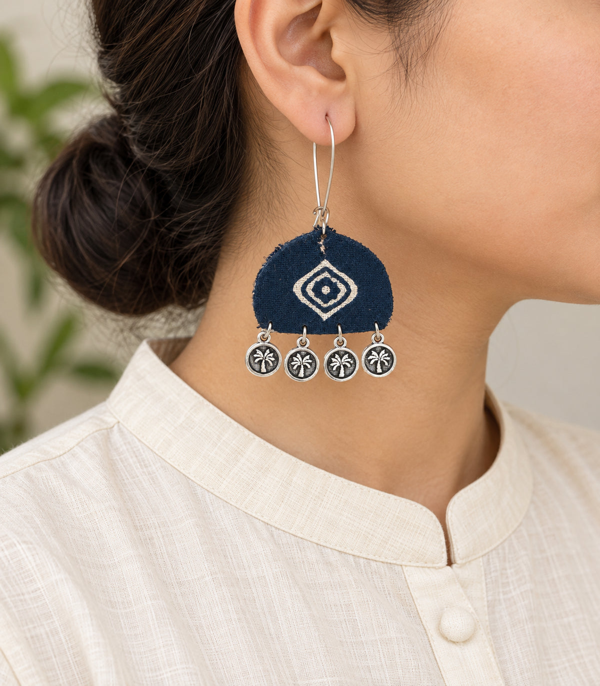 Navy and ivory diamond motif coin earrings — model view