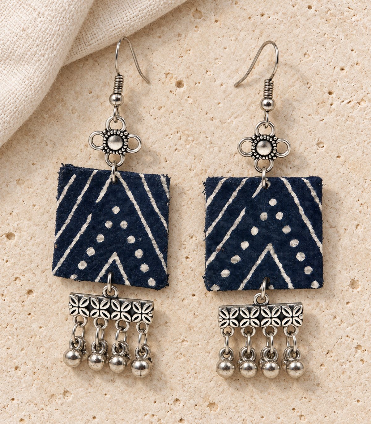 Navy and ivory square floral fringe fabric earrings — editorial flatlay view
