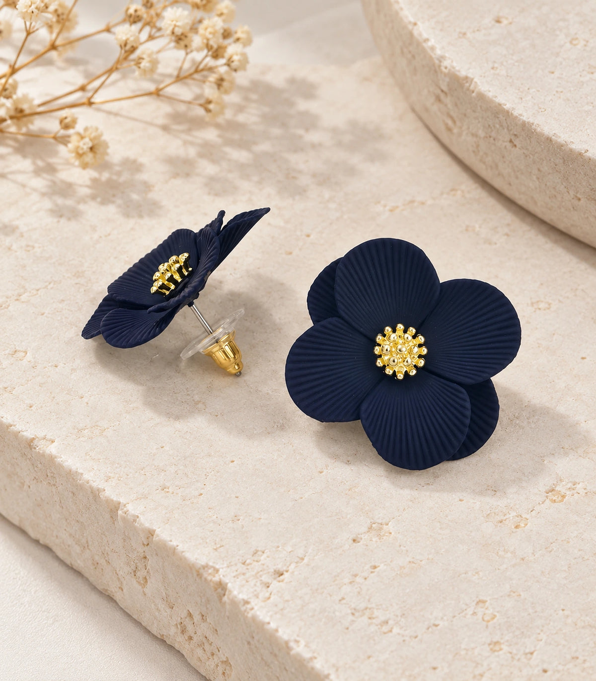 JIMIKI Navy ribbed flower stud earrings, pair arranged in an editorial flat lay #color_navy