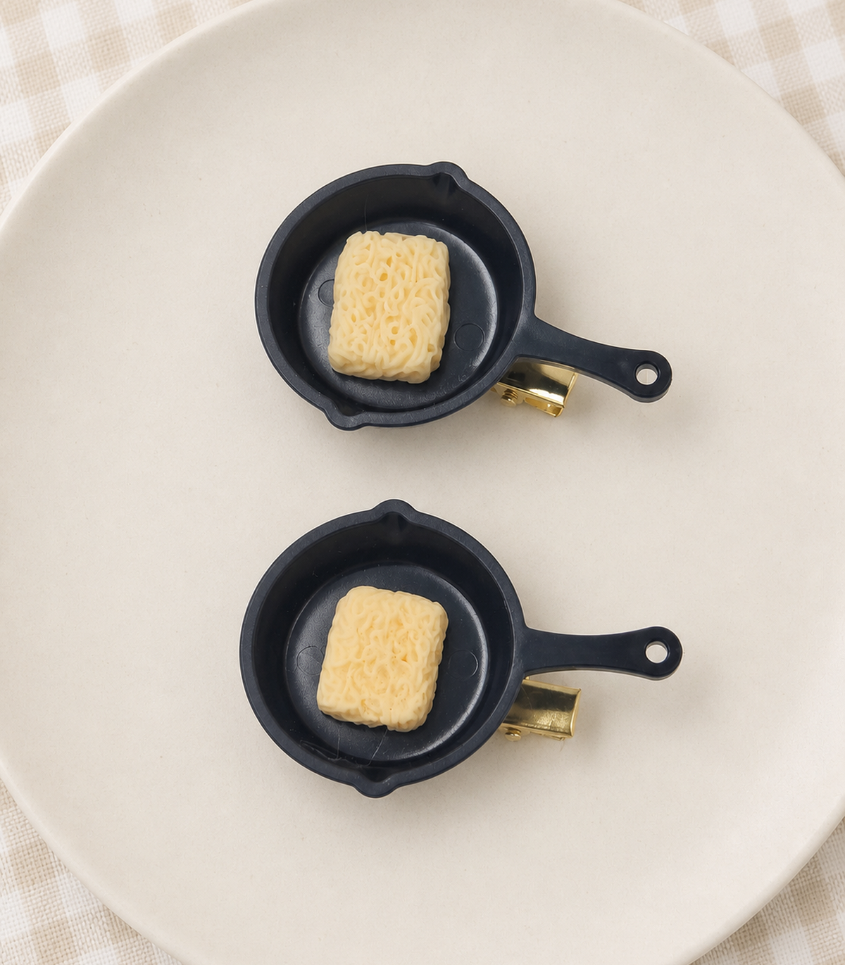 Noodle Pan Barrette Pair editorial flat lay