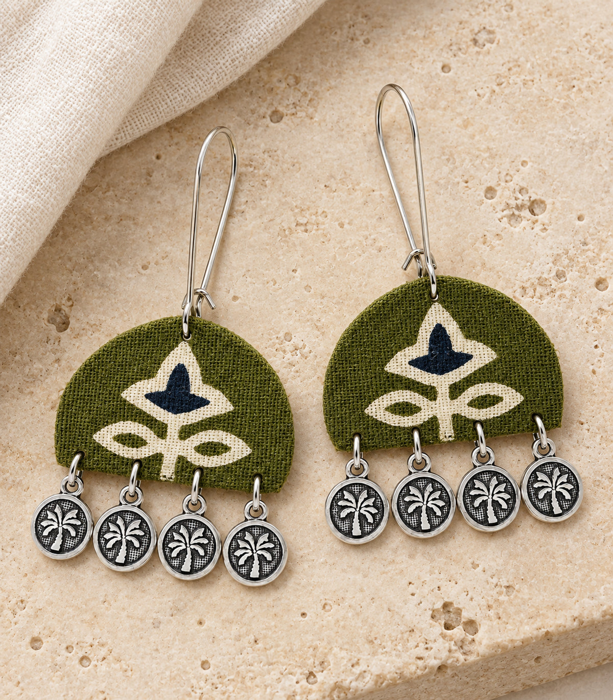 Olive and navy floral coin drop earrings — editorial flatlay view