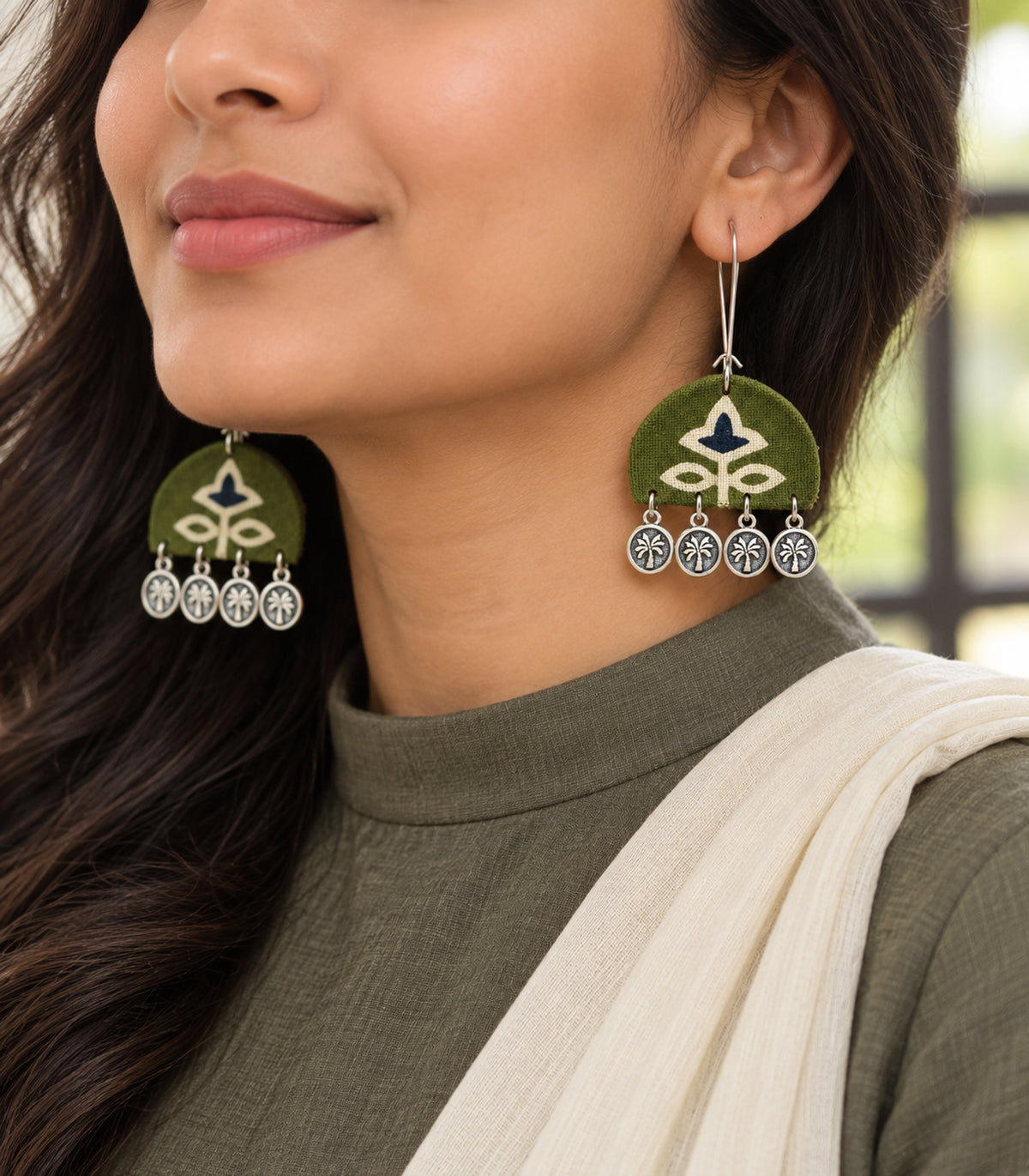 Olive and navy floral coin drop earrings — editorial model view