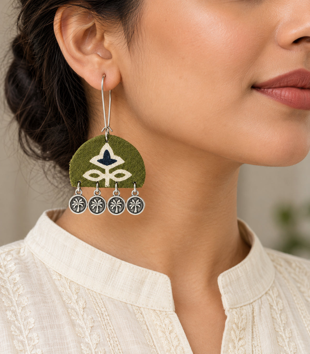 Olive and navy floral coin drop earrings — model view