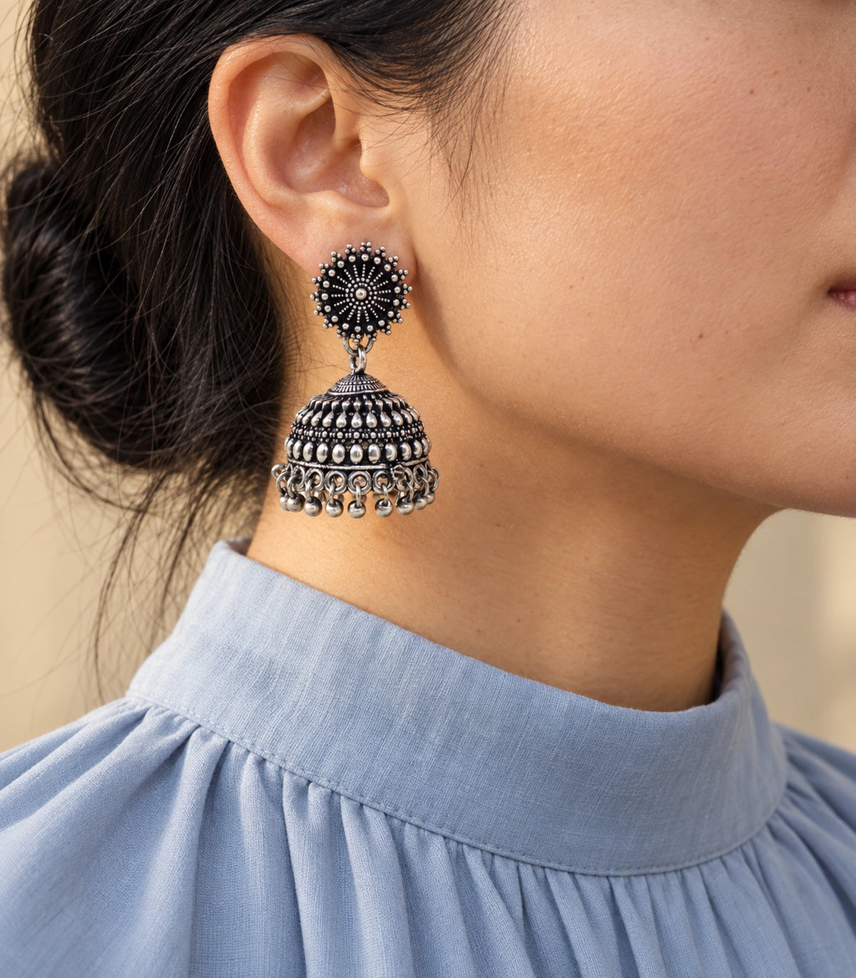 JIMIKI Oxidized Silver Beaded Sunburst Jhumka Earrings - styled model wearing the earring #color_oxidized-silver