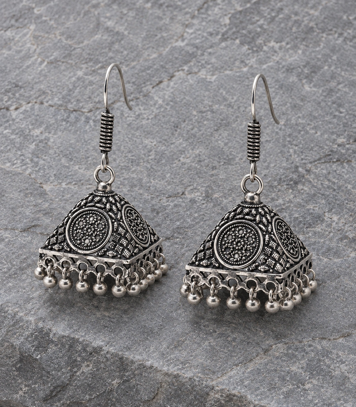 JIMIKI Oxidized Silver Floral Medallion Pyramid Jhumka Earrings - Pair arranged in an editorial flatlay #color_oxidized-silver