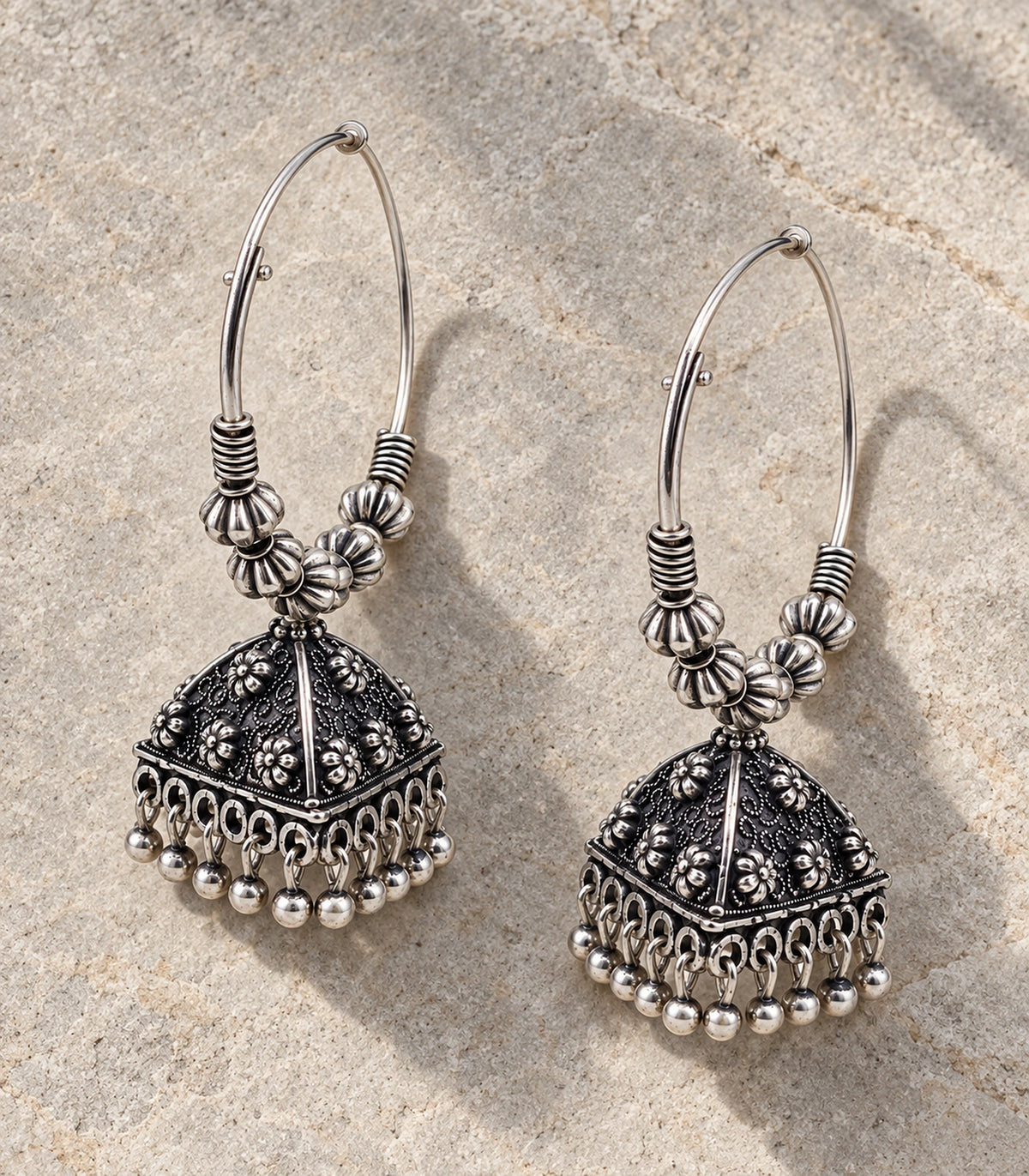 JIMIKI Oxidized Silver Floral Pyramid Beaded Hoop Jhumka Earrings - Pair arranged in an editorial flatlay #color_oxidized-silver