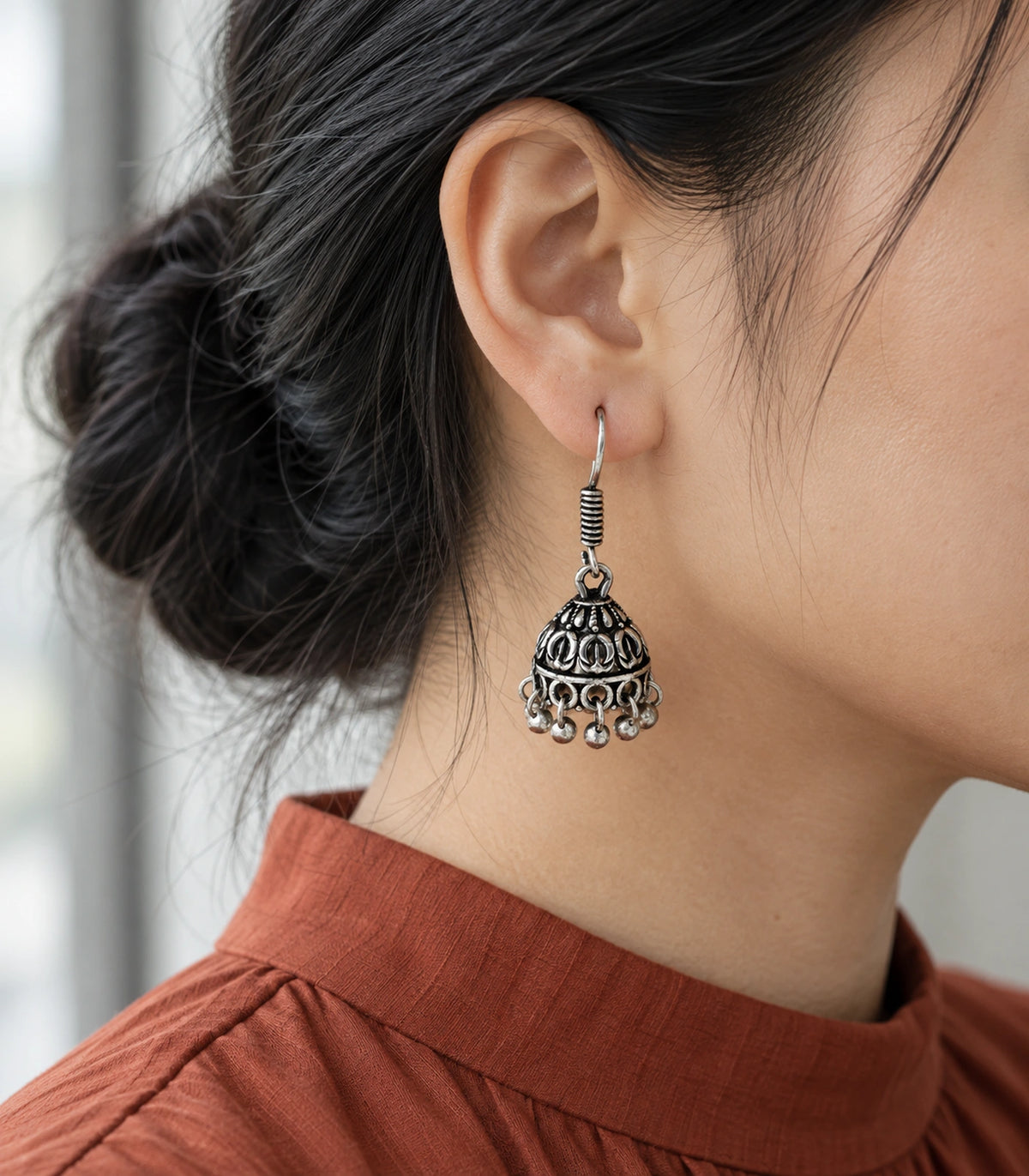 JIMIKI Oxidized Silver Leaf Motif Mini Jhumka Earrings - styled model wearing the earring #color_oxidized-silver
