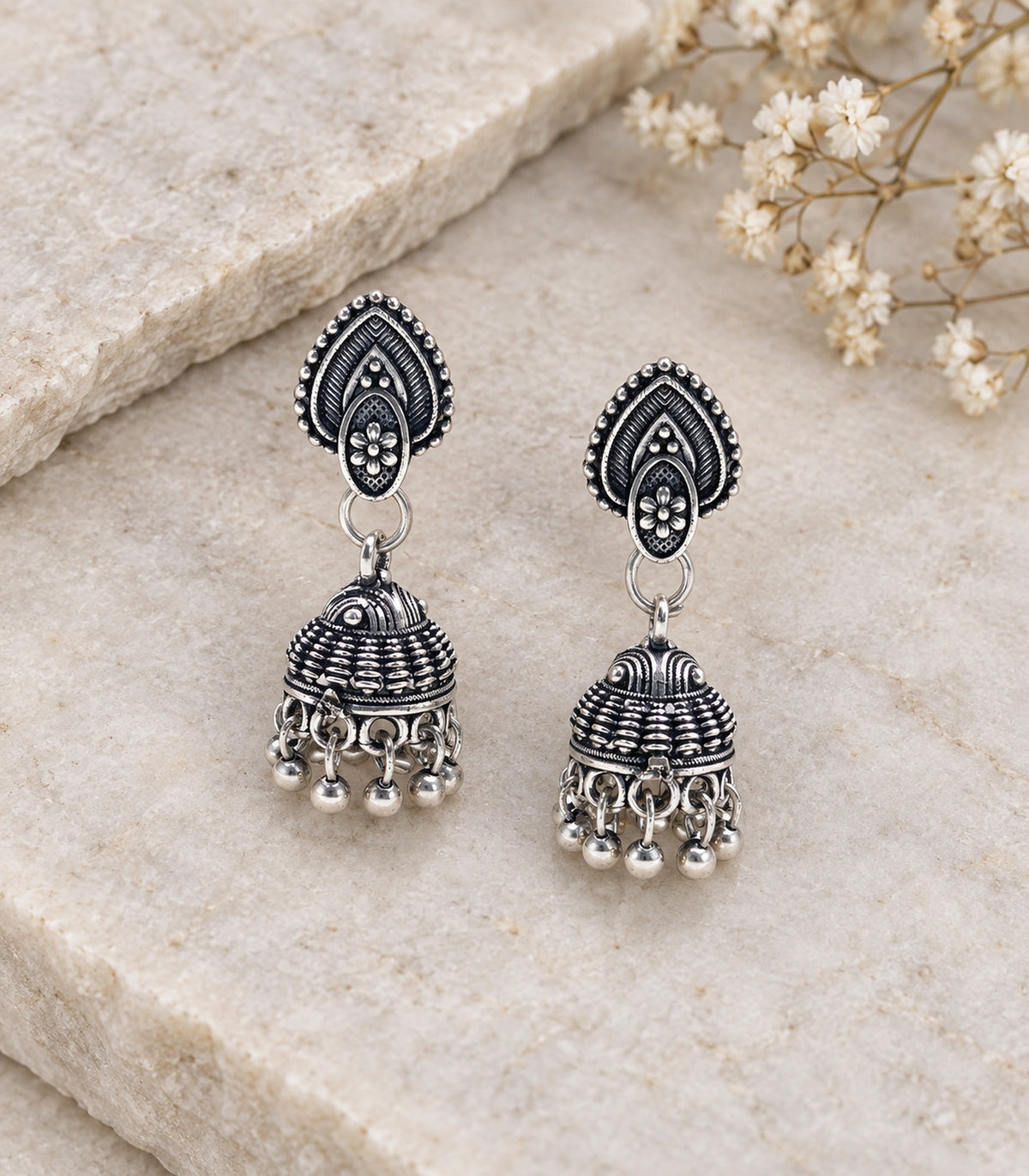JIMIKI Leaf Stud Beaded Jhumka Earrings - Oxidized Silver styled flatlay of the matching earrings #color_oxidized-silver
