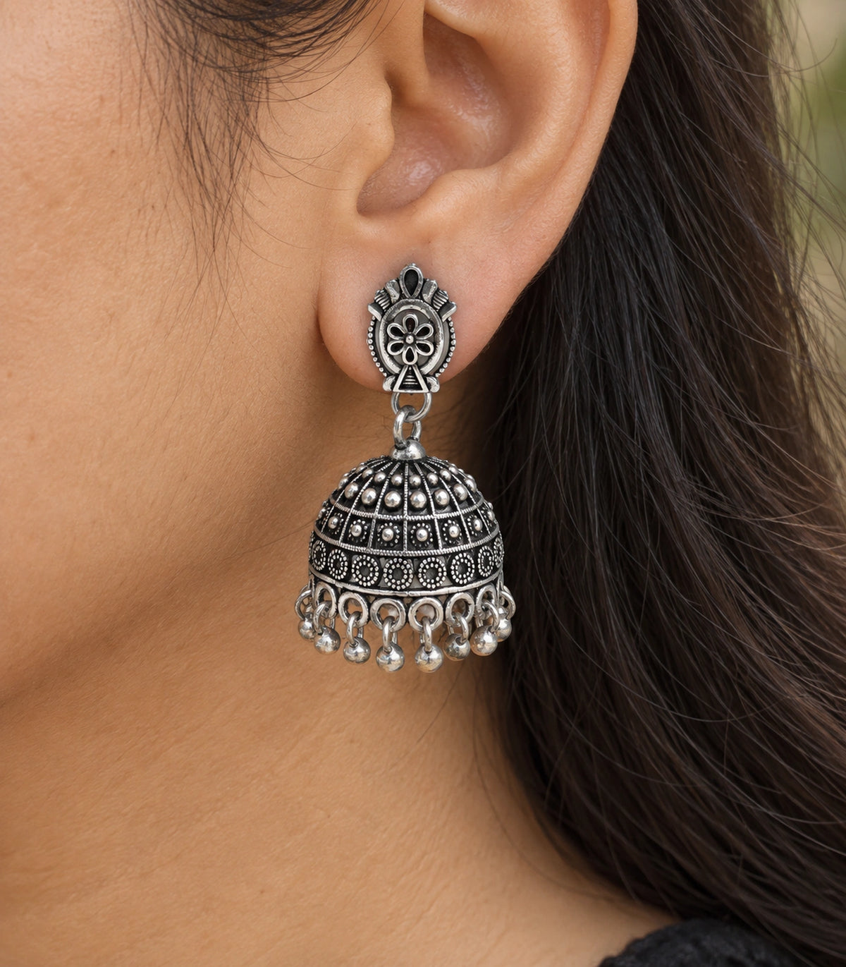 JIMIKI Oxidized Silver Oval Flower Grid Dome Jhumka Earrings - close-up of the earring worn #color_oxidized-silver