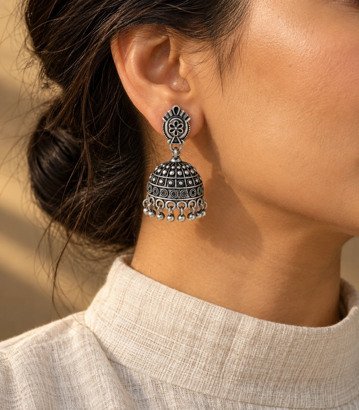 JIMIKI Oxidized Silver Oval Flower Grid Dome Jhumka Earrings - styled model wearing the earring #color_oxidized-silver