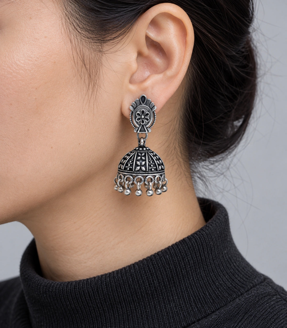 JIMIKI Oxidized Silver Oval Flower Stud Panel Jhumka Earrings in Oxidized Silver - worn styling view #color_oxidized-silver