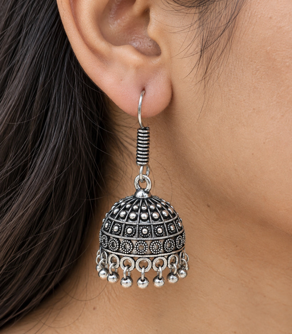 JIMIKI Oxidized Silver Rosette Grid Dome Jhumka Earrings - close-up of the earring worn #color_oxidized-silver