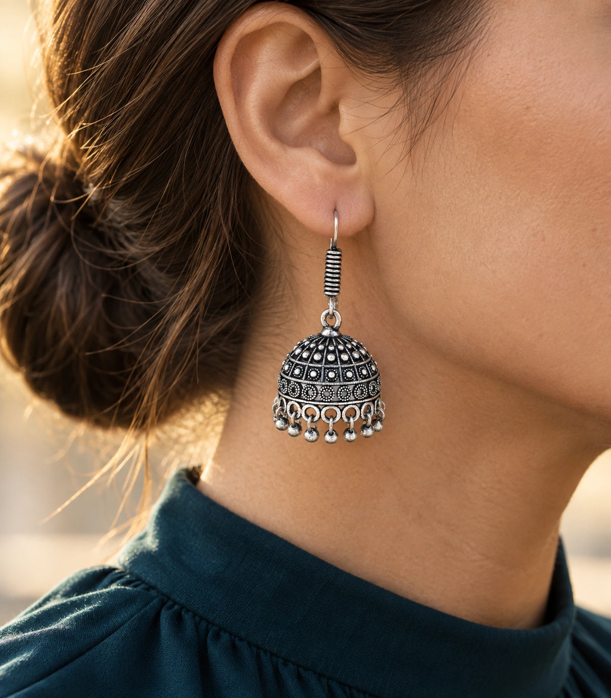 JIMIKI Oxidized Silver Rosette Grid Dome Jhumka Earrings - styled model wearing the earring #color_oxidized-silver